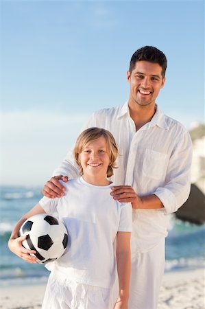 parents cheering for kid soccer - Father and his son on the beach Stock Photo - Budget Royalty-Free & Subscription, Code: 400-04338890