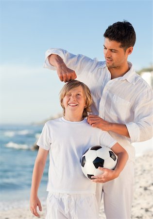 parents cheering for kid soccer - Father and his son on the beach Stock Photo - Budget Royalty-Free & Subscription, Code: 400-04338891