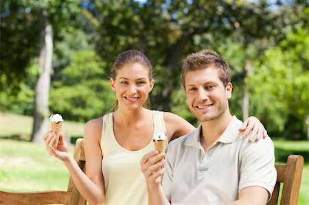 Couple eating an ice cream in the park Stock Photo - Budget Royalty-Free & Subscription, Code: 400-04338957