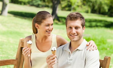Couple eating an ice cream in the park Stock Photo - Budget Royalty-Free & Subscription, Code: 400-04338959