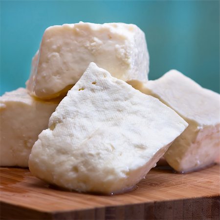 Big slices of Curd cheese on cutting board. * Selective focus. Stock Photo - Budget Royalty-Free & Subscription, Code: 400-04339057