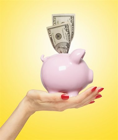 simsearch:400-04995456,k - piggy bank with dollars on woman hand over yellow background Stockbilder - Microstock & Abonnement, Bildnummer: 400-04339131