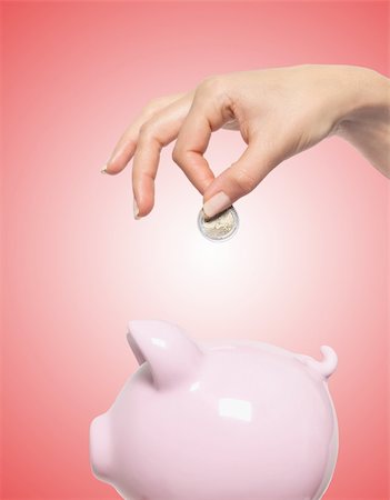 simsearch:400-04995456,k - Hand putting money into the piggy bank isolated on white Stockbilder - Microstock & Abonnement, Bildnummer: 400-04339245