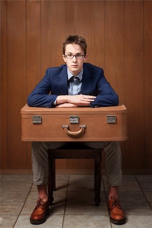 Serious Caucasian man sitting on chair with suitcase Stock Photo - Budget Royalty-Free & Subscription, Code: 400-04339465