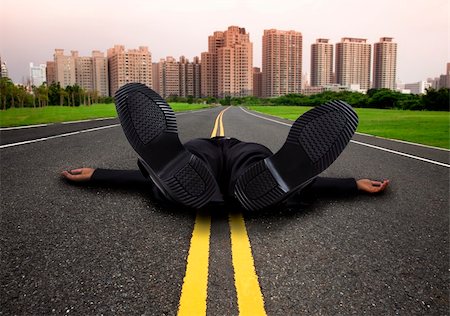people lying down on the road - businessman tired and Exhausted on the empty  road to the city Stock Photo - Budget Royalty-Free & Subscription, Code: 400-04339515