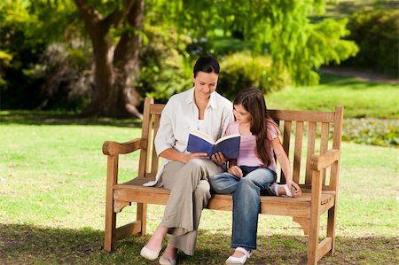 portrait of family on park bench - Mother and her daughter reading a book Stock Photo - Budget Royalty-Free & Subscription, Code: 400-04339538