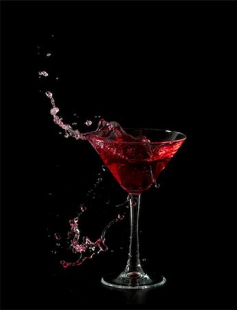 simsearch:400-06409646,k - red martini cocktail splashing into glass on black background Stock Photo - Budget Royalty-Free & Subscription, Code: 400-04330914
