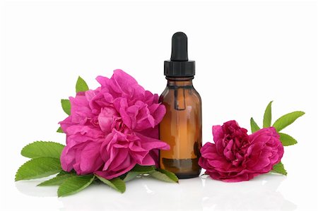 rose essential oil - Rose flowers with aromatherapy essential oil glass bottle isolated over white background. Stock Photo - Budget Royalty-Free & Subscription, Code: 400-04331072