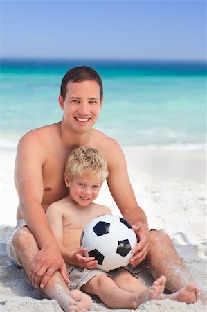 Son playing football with his father Stock Photo - Budget Royalty-Free & Subscription, Code: 400-04331332