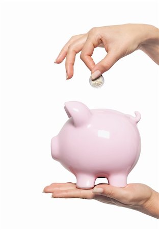 simsearch:400-04995456,k - Hand putting money into the piggy bank isolated on white Foto de stock - Super Valor sin royalties y Suscripción, Código: 400-04331455