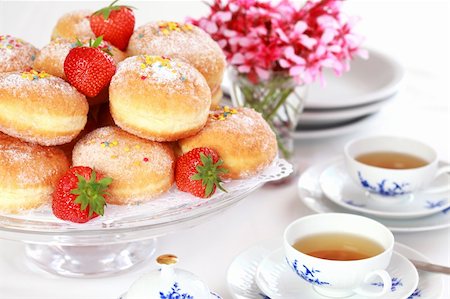 simsearch:400-04677383,k - Doughnut filled with strawberry jam - German national dish with cup of tea Stock Photo - Budget Royalty-Free & Subscription, Code: 400-04332558