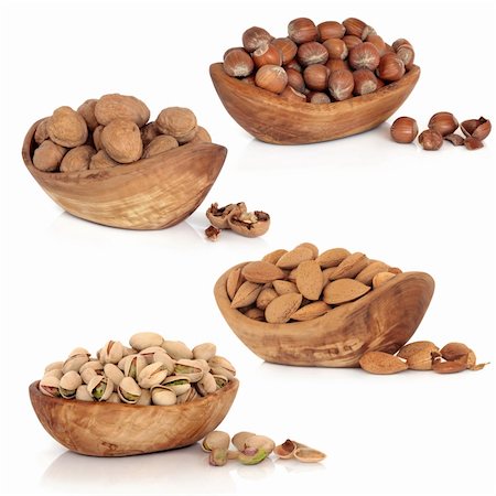 simsearch:400-04181279,k - Nut collection of walnut, pistachio, almond and hazelnut in rustic wooden bowls, isolated over white background. Foto de stock - Super Valor sin royalties y Suscripción, Código: 400-04333322