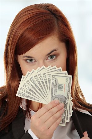 simsearch:400-05718322,k - Businesswoman holding dollars Fotografie stock - Microstock e Abbonamento, Codice: 400-04333372