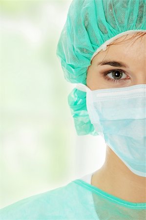 doctor with cap and mask - Close-up portrait of serious nurse or doctor in mask Stock Photo - Budget Royalty-Free & Subscription, Code: 400-04333382