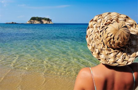 simsearch:400-04718145,k - Closeup image of a young woman in a straw hat and bikini, looking at a tiny island in the Mediterranean Photographie de stock - Aubaine LD & Abonnement, Code: 400-04333830