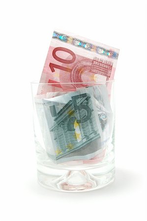Some euro banknotes in a tumbler isolated on white background Stock Photo - Budget Royalty-Free & Subscription, Code: 400-04333910