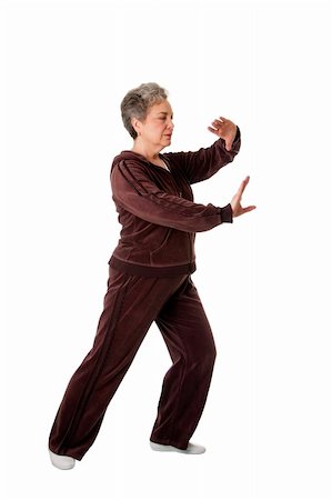 Beautiful Senior woman doing Tai Chi exercise to keep her joints flexible, isolated. Photographie de stock - Aubaine LD & Abonnement, Code: 400-04344220