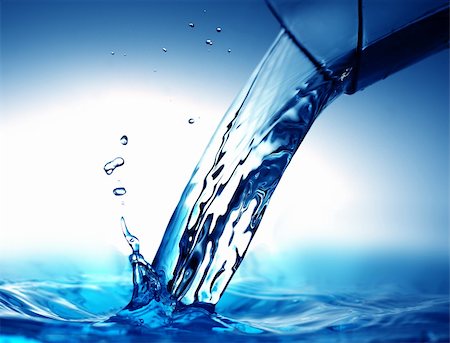 fresh spring drinking water - drinking water pouring from glass on blue Stock Photo - Budget Royalty-Free & Subscription, Code: 400-04344281