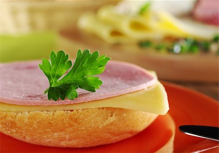 plate of cold cuts and cheeses - Open sandwich with a cold meat slice and cheese slice with parsley on top on orange plate with knife, and ingredients in the background (Selective Focus, Focus on the front of the bun, the slices and the parsley) Stock Photo - Budget Royalty-Free & Subscription, Code: 400-04345360