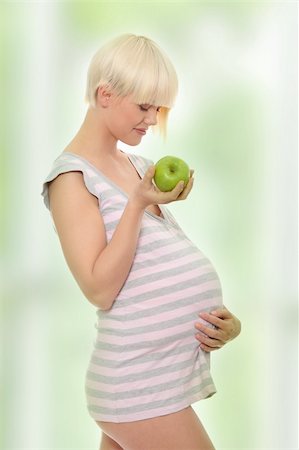 fashion for mother baby - Young pregnant woman with green apple Stock Photo - Budget Royalty-Free & Subscription, Code: 400-04345397