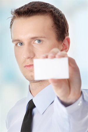 Businessman holding white blank businesscard Stock Photo - Budget Royalty-Free & Subscription, Code: 400-04345393
