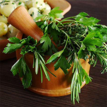 simsearch:400-04348087,k - Fresh herbs (parsley, rosemary and thyme) in wooden mortar with pestle (Selective Focus, Focus on the front of the herbs) Stock Photo - Budget Royalty-Free & Subscription, Code: 400-04345436