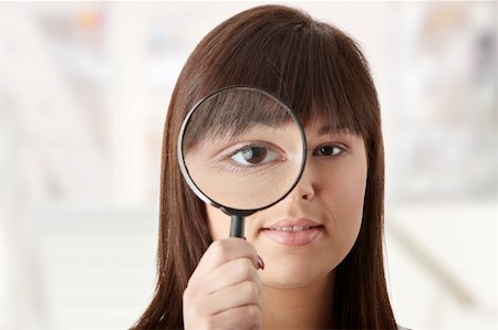 simsearch:400-04554899,k - Young attractive smiling business woman looking into a magnifying glass Stock Photo - Budget Royalty-Free & Subscription, Code: 400-04345493