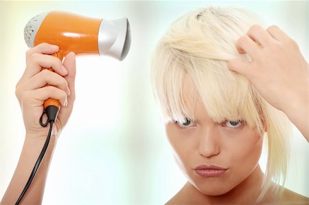 simsearch:400-05677974,k - Young blonde woman using hair drier Foto de stock - Super Valor sin royalties y Suscripción, Código: 400-04345511