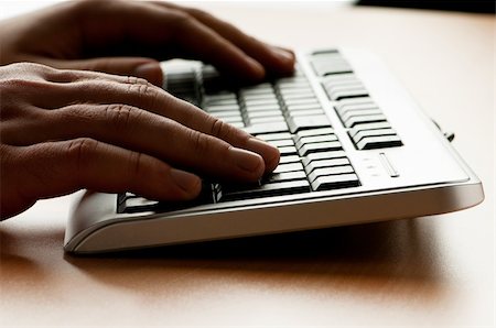 Two hands working on the silver keyboard Stock Photo - Budget Royalty-Free & Subscription, Code: 400-04345697