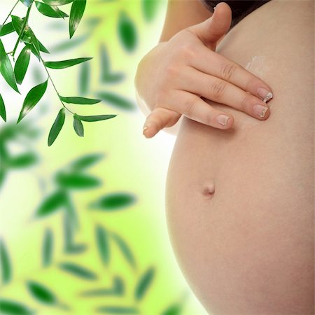 simsearch:400-05084530,k - Young pregnant woman rubs cream into her belly Foto de stock - Super Valor sin royalties y Suscripción, Código: 400-04345736