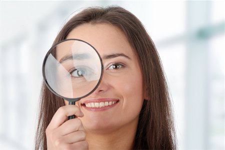 simsearch:400-04554899,k - The woman with a magnifier in a hand on the isolated background Stock Photo - Budget Royalty-Free & Subscription, Code: 400-04345796