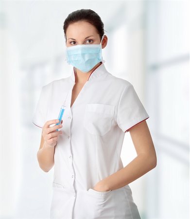 simsearch:400-04626468,k - Young nurse in mask with syringe, isolated on white background Stockbilder - Microstock & Abonnement, Bildnummer: 400-04345880