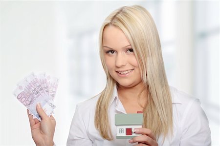 simsearch:400-04350998,k - Beautiful young woman holding euros bills and house model over white Stock Photo - Budget Royalty-Free & Subscription, Code: 400-04345902