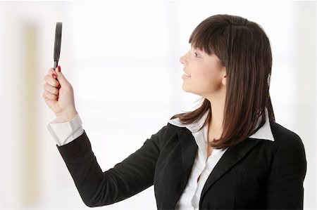 simsearch:400-04554899,k - Young attractive smiling business woman looking into a magnifying glass Stock Photo - Budget Royalty-Free & Subscription, Code: 400-04346309