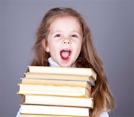 Little school girl with books.  Studio shot. Stock Photo - Budget Royalty-Free & Subscription, Code: 400-04346675