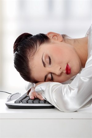 Young businesswoman sleeping on the keyboard in the office. Foto de stock - Super Valor sin royalties y Suscripción, Código: 400-04346778