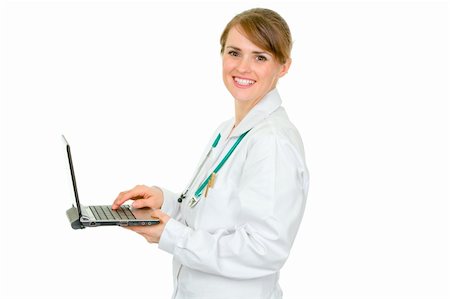 simsearch:400-04351236,k - Smiling medical female doctor using laptop isolated on white Photographie de stock - Aubaine LD & Abonnement, Code: 400-04347288