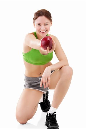 Portrait of woman in sportswear with apple Stockbilder - Microstock & Abonnement, Bildnummer: 400-04347307