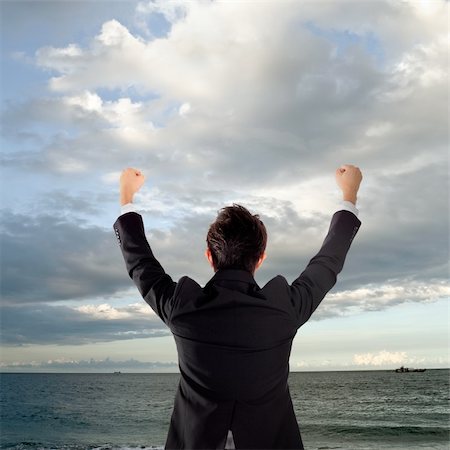 elwynn (artist) - Cheerful business man standing in outside of ocean and rising hands. Foto de stock - Royalty-Free Super Valor e Assinatura, Número: 400-04347595