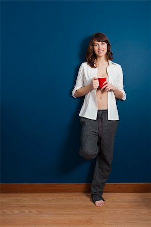 Beautiful young woman wearing a casual lingerie against a blue wall, and drinking coffee Stock Photo - Budget Royalty-Free & Subscription, Code: 400-04347967