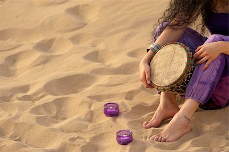 Girl with a djembe enjoying  on a sunny beach Stock Photo - Budget Royalty-Free & Subscription, Code: 400-04348193