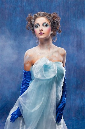 Beautiful girl like Snow White on blue background Stockbilder - Microstock & Abonnement, Bildnummer: 400-04349083