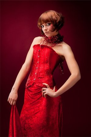 Beautiful girl in red dress over on red background Stockbilder - Microstock & Abonnement, Bildnummer: 400-04349123