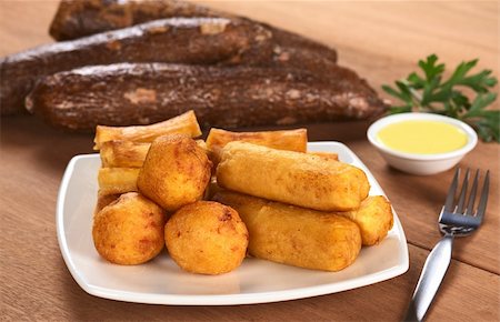 simsearch:400-04852542,k - Filled fried balls and sticks out of manioc with a dip and some manioc roots in the back (Selective Focus, Focus on the manioc balls and the manioc sticks in the front) Stockbilder - Microstock & Abonnement, Bildnummer: 400-04349188