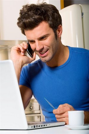 man in the kitchen with laptop Stock Photo - Budget Royalty-Free & Subscription, Code: 400-04349256