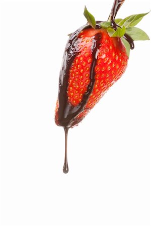 Beautiful girl eating a fresh red strawberry with chocolate sauce Foto de stock - Super Valor sin royalties y Suscripción, Código: 400-04349753