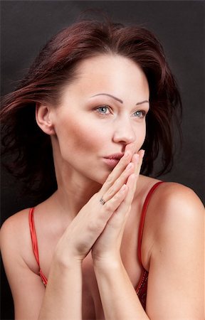 simsearch:400-04363188,k - The model is in the center of the frame. She does not look at the camera. Hands folded in her mouth. Black background Stock Photo - Budget Royalty-Free & Subscription, Code: 400-04340353