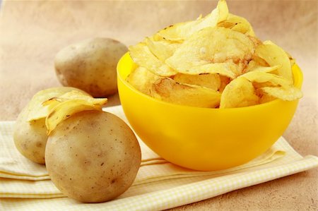 potato chips in a yellow cup, and fresh potato Stock Photo - Budget Royalty-Free & Subscription, Code: 400-04340523