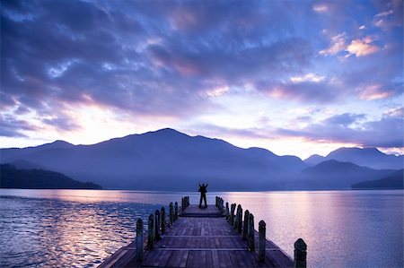 simsearch:400-07617810,k - Man stand on a pier and watching the mountains and lake Stockbilder - Microstock & Abonnement, Bildnummer: 400-04340637