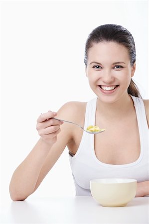 A pretty young girl has corn flakes on a white background Stock Photo - Budget Royalty-Free & Subscription, Code: 400-04340884